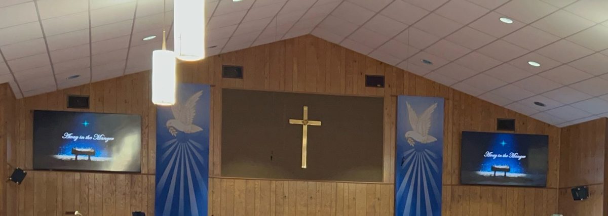 The sanctuary at Noonday Methodist Church, with the cross and dove banners on display.